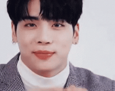 A Close Up Of A Young Man Wearing A Suit And Turtleneck Sweater . GIF