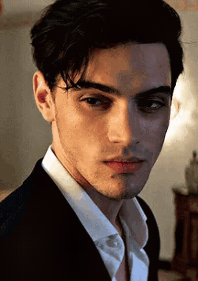 A Close Up Of A Young Man Wearing A Suit And White Shirt . GIF