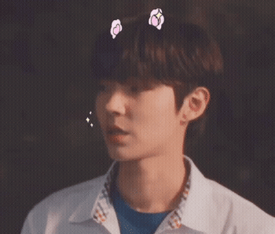 A Close Up Of A Young Man Wearing A White Shirt And A Blue Shirt With Hearts On His Head . GIF