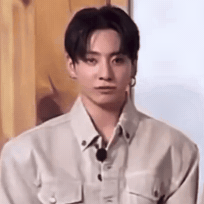 A Close Up Of A Young Man Wearing A White Shirt And A Microphone . GIF