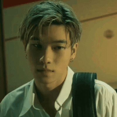 A Close Up Of A Young Man Wearing A White Shirt And Carrying A Backpack . GIF