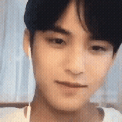 A Close Up Of A Young Man Wearing Ear Buds . GIF
