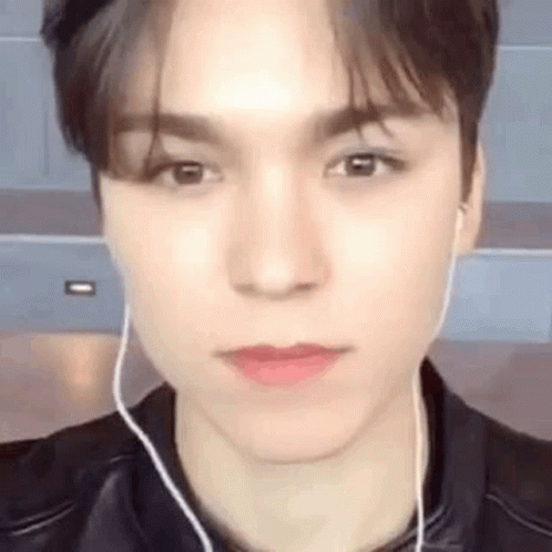 A Close Up Of A Young Man Wearing Earphones And A Leather Jacket . GIF