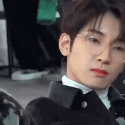 A Close Up Of A Young Man Wearing Glasses And A Suit . GIF