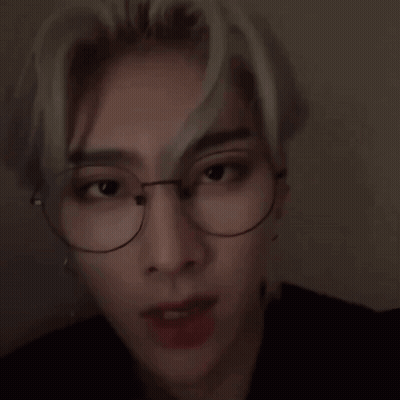 A Close Up Of A Young Man Wearing Glasses And Earrings . GIF