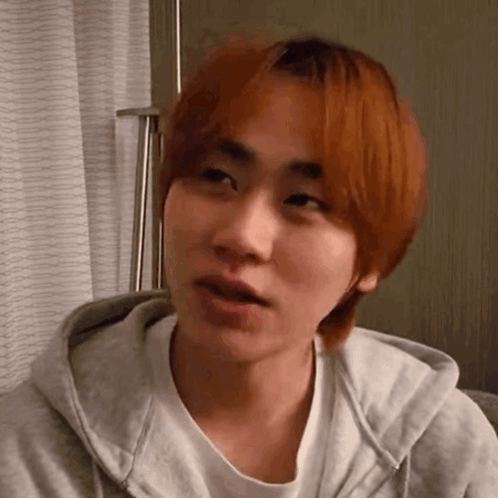 A Close Up Of A Young Man With Red Hair Wearing A Hoodie . GIF