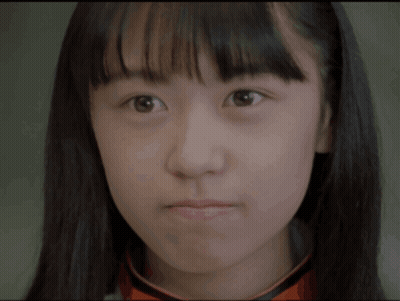 A Close Up Of A Young Woman 'S Face With A Serious Look On Her Face GIF