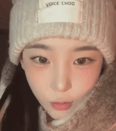 A Close Up Of A Young Woman Wearing A Hat And Scarf . GIF