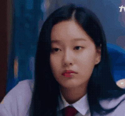 A Close Up Of A Young Woman Wearing A White Shirt And Red Tie . GIF
