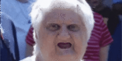 A Close Up Of An Elderly Woman 'S Face With A Devil 'S Face On It . GIF