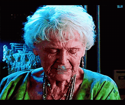A Close Up Of An Elderly Woman 'S Face With Her Eyes Closed And The Words " Duck In The Dark " Written On Her Mouth GIF