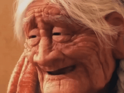 A Close Up Of An Elderly Woman 'S Face With Her Eyes Closed . GIF