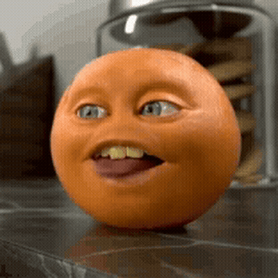 A Close Up Of An Orange With A Funny Face GIF