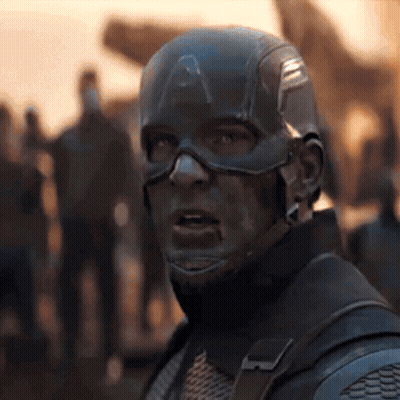 A Close Up Of Captain America 'S Face With A Crowd Of People In The Background GIF