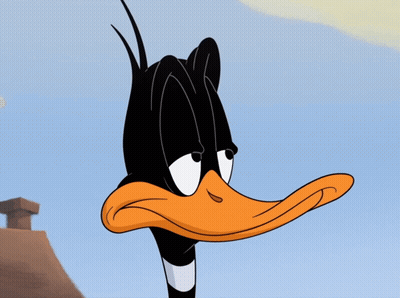 A Close Up Of Daffy Duck 'S Face With A Chimney Behind Him GIF