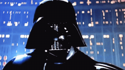 A Close Up Of Darth Vader 'S Face In Front Of A Wall GIF