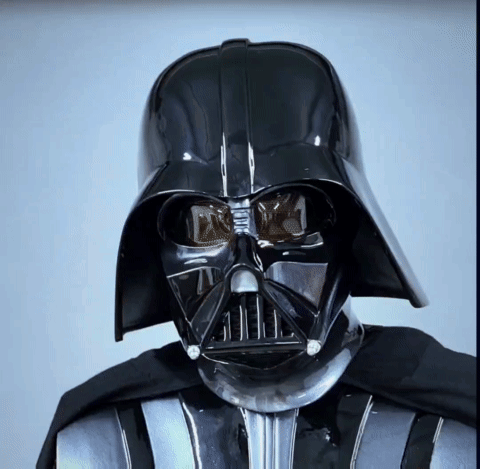 A Close Up Of Darth Vader 'S Face With A Black Helmet GIF