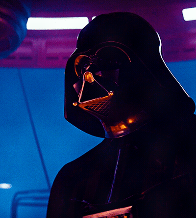 A Close Up Of Darth Vader 'S Face With A Blue Background GIF