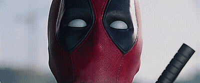 A Close Up Of Deadpool 'S Face With A Sword . GIF