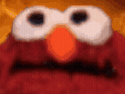 A Close Up Of Elmo 'S Face With A Blurred Background GIF