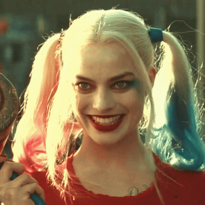 A Close Up Of Harley Quinn 'S Face With Pigtails GIF