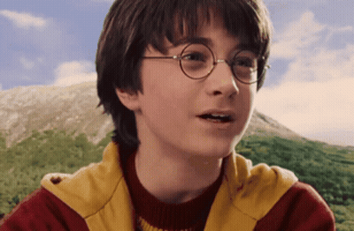 A Close Up Of Harry Potter Wearing Glasses And A Red And Yellow Jacket GIF