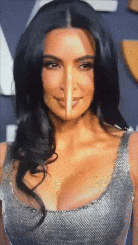A Close Up Of Kim Kardashian 'S Face With A Pencil Sticking Out Of It GIF