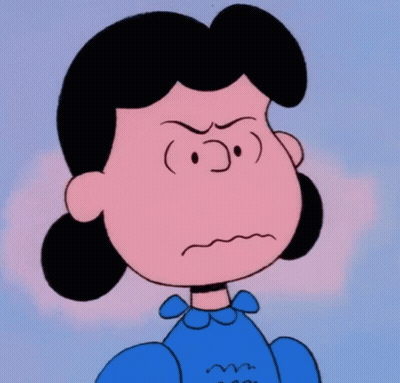 A Close Up Of Lucy Brown From The Peanuts Showing An Angry Look On Her Face GIF