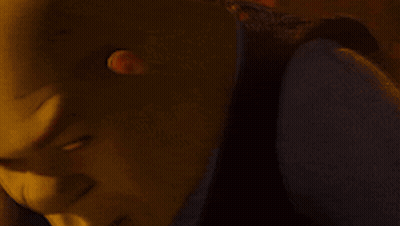 A Close Up Of Shrek 'S Face With A Yellow Background GIF