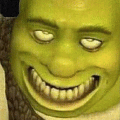 A Close Up Of Shrek 'S Face With White Eyes And A Big Smile GIF
