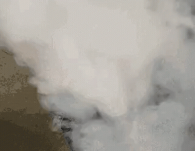 A Close Up Of Smoke Coming Out Of A Stove . GIF