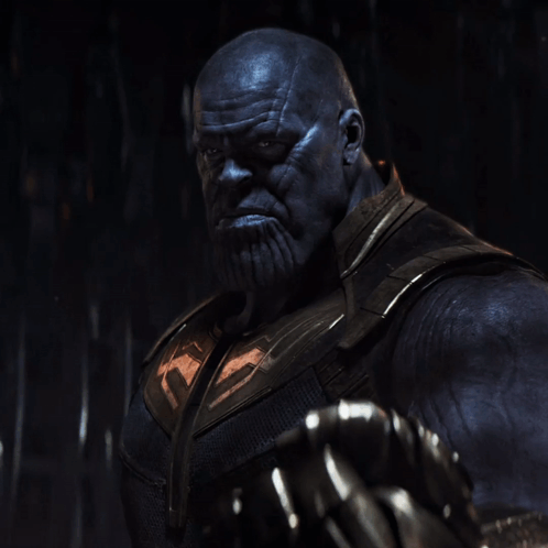 A Close Up Of Thanos With A Beard And Gloves GIF