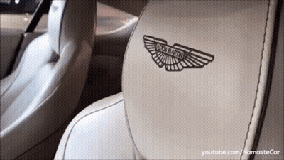 A Close Up Of The Back Seat Of A Car With The Aston Martin Logo On It GIF