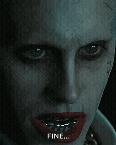 A Close Up Of The Face Of The Joker From The Movie Suicide Squad With Braces On His Teeth . GIF