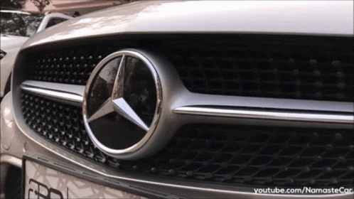 A Close Up Of The Front Of A Silver Mercedes Benz Car GIF