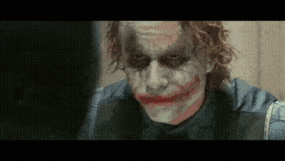 A Close Up Of The Joker 'S Face With A Fake Smile GIF