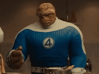 A Close Up Of The Thing 'S Face With A Blue Shirt GIF