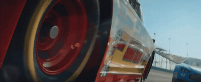 A Close Up Of The Wheel Of A Race Car On A Race Track . GIF