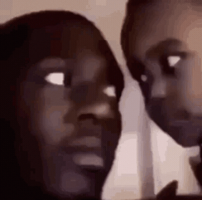A Close Up Of Two People 'S Faces Looking At Each Other With Their Eyes Closed . GIF
