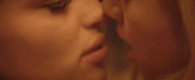 A Close Up Of Two Women Looking At Each Other 'S Faces GIF