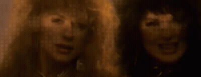 A Close Up Of Two Women With Their Mouths Open . GIF