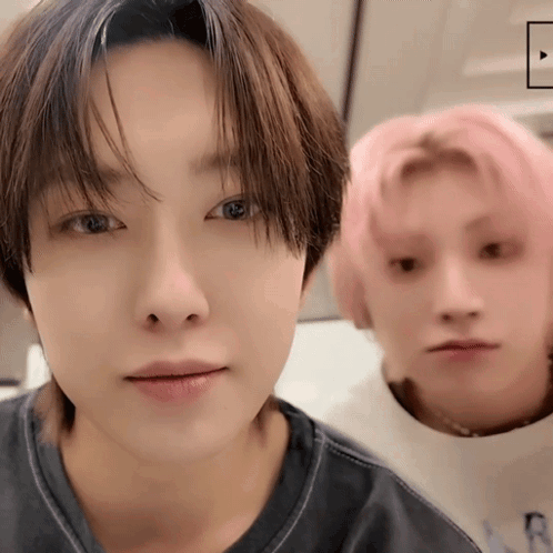 A Close Up Of Two Young Men With Pink Hair GIF