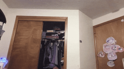 A Closet With Clothes Hanging And A Sticker On The Door That Says ' I Love You ' GIF