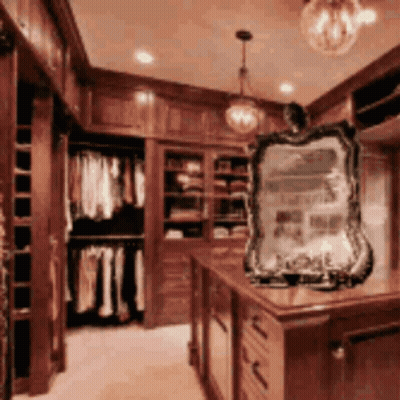 A Closet With Lots Of Clothes And A Mirror In The Middle GIF