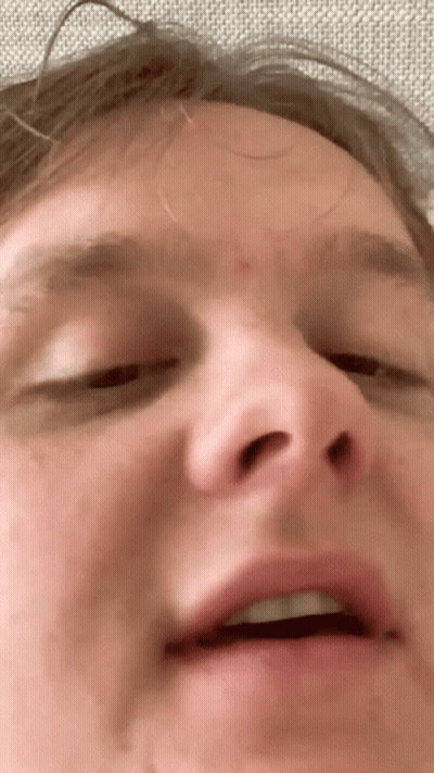 A Closeup Of A Man 'S Face With His Eyes Closed GIF
