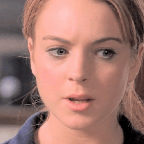 A Closeup Of A Woman 'S Face With Her Mouth Open GIF