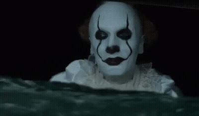 A Clown Is Holding A Slice Of Pizza In His Hand In The Water . GIF