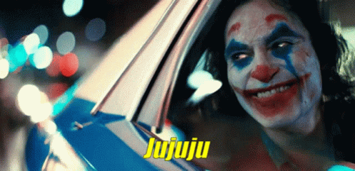 A Clown Is Smiling In A Car With The Word Jujuju On The Bottom Right GIF