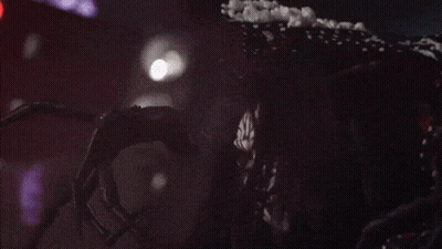 A Clown With A Polka Dot Dress Is Laughing With His Mouth Open GIF
