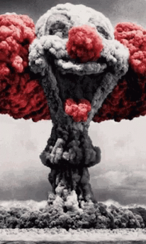 A Clown With A Red Nose Is Coming Out Of An Explosion . GIF